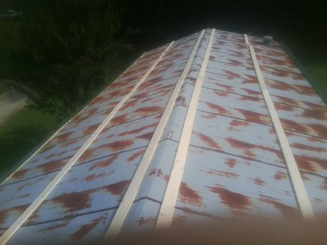 Rusted metal roof panels with new wood purlins before replacement — Storm Damage Roof Repair in Saint Lucas by Roofing Brothers